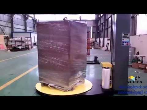 Automatic pallet stretch wrapping machine with forklift channel