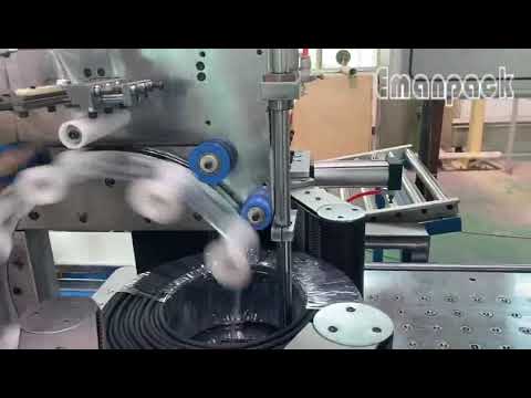 Integrated cable winder and coil wrapper machine making cable coils