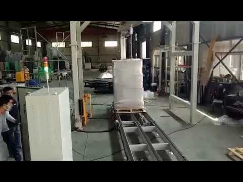 Rotary arm pallet wrapping machine