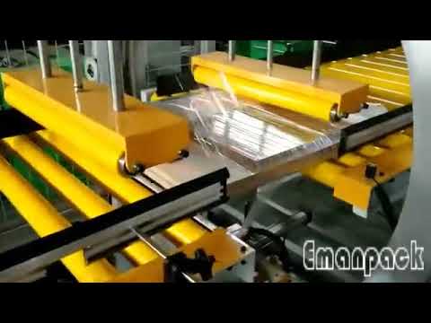 Orbital stretch wrapping machine with side panels for packing board