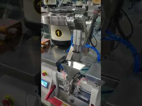 Autobag machine with double vibrating bowl feeders for screws packing into small bags.