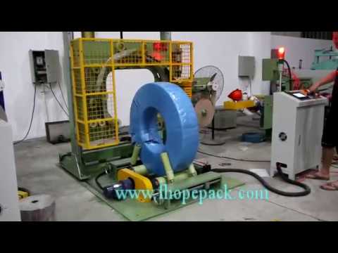 wire coil packing machine with wrapping station movement