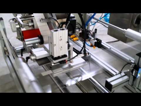 Automatic Film Top Labeling Machine on Horizontal Wrapper - Tamp on type 吸貼式膠膜自動貼標機