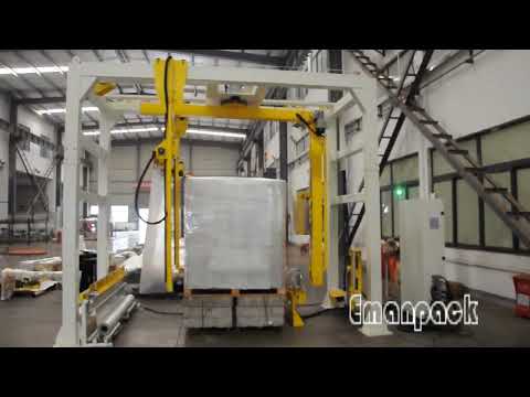 Rotary arm pallet stretch wrapping machine with top film dispenser