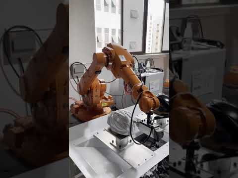 Robot arm in helmet manufacturing