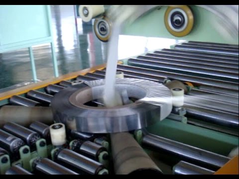 Coil packing machine with end tapping