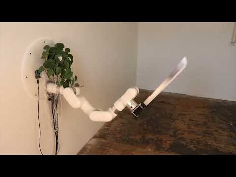 living plant controls a machete through an industrial robot arm