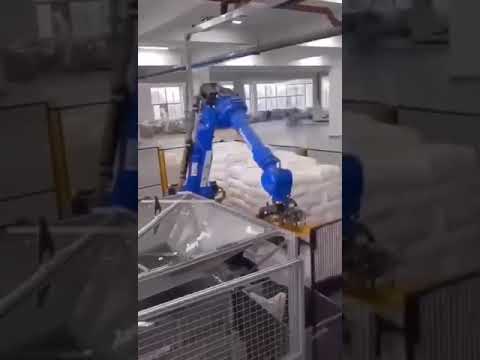 Robot arm carry out bags, cutting the bag and spray on a mix tank