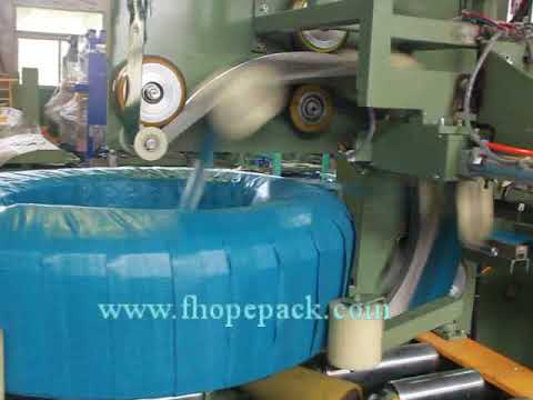 Automatic coil stretch wrapping machine with end sealer