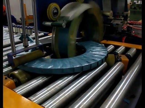 Coil packing line for wrapping and tapping