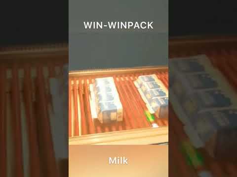 Milk packs by shrink wrapping machine which push the milk boxes on the machine and wrap by POF film